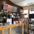 Load image into Gallery viewer, image of inside the Kind Coffee shop showing the menu and back of espresso machine. 

